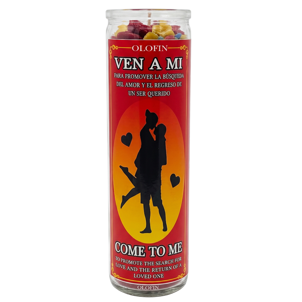 A tall glass jar candle with a red and orange label reading 'OLEFIN VEN A MI' and 'COME TO ME,' featuring a black silhouette of a couple on a yellow-orange circle, with rose petals visible at the top.
