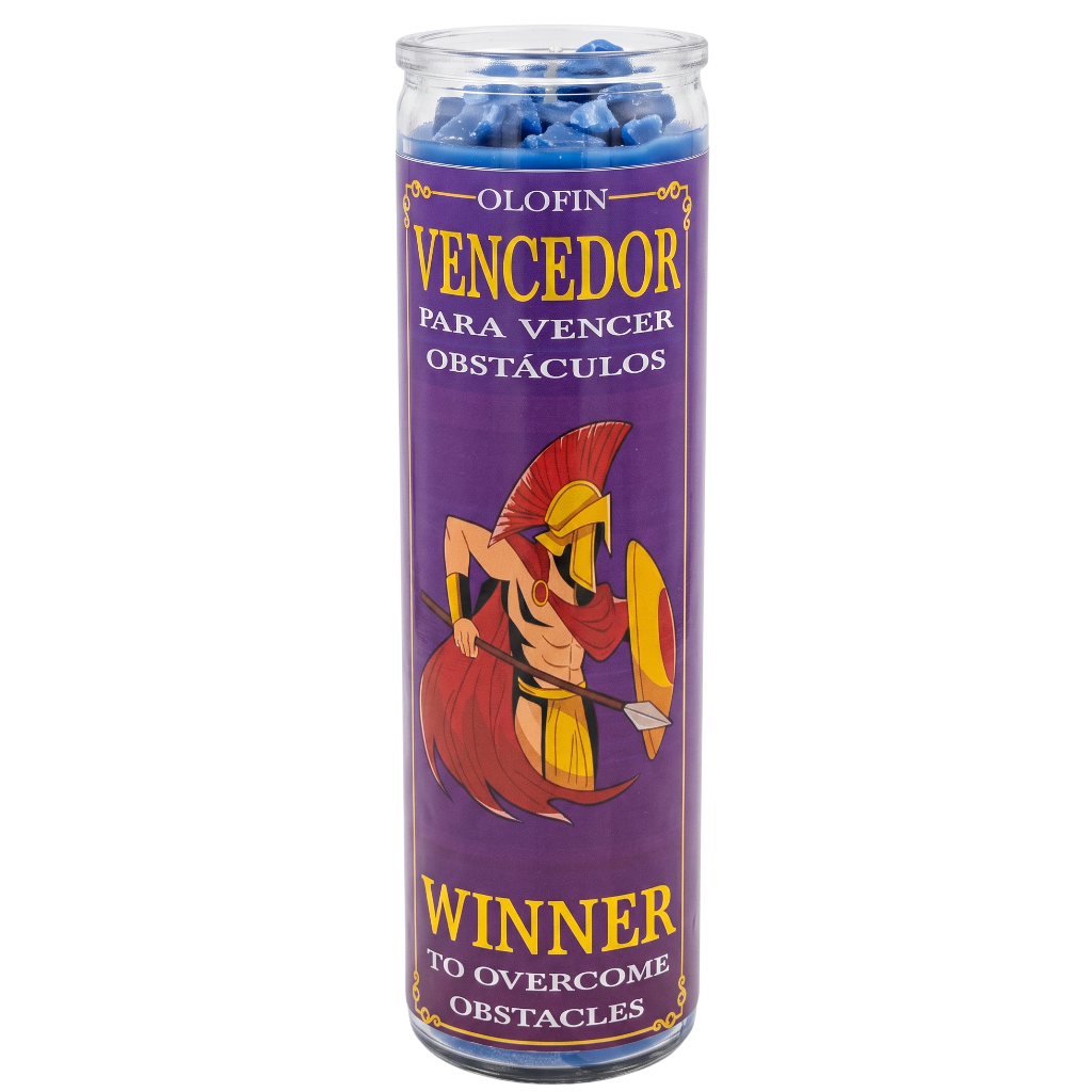 A tall glass jar candle with a purple label featuring a Spartan warrior illustration and Spanish text reading 'Olofin Vencedor para vencer obstáculos' and 'Winner to overcome obstacles.' Blue wax is visible at the top.
