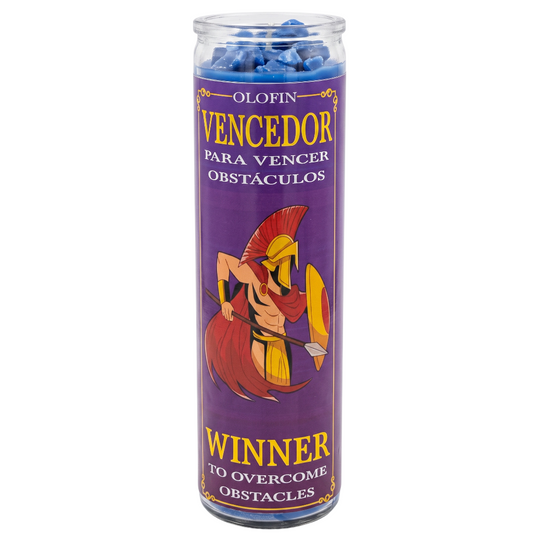 A tall glass jar candle with a purple label featuring a Spartan warrior illustration and Spanish text reading 'Olofin Vencedor para vencer obstáculos' and 'Winner to overcome obstacles.' Blue wax is visible at the top.