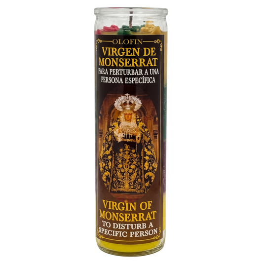 A tall glass jar candle labeled 'Olofin Virgen de Monserrat' with Spanish and English text, featuring a dark brown label with gold and white lettering and an illustration of the Virgin of Monserrat. The candle contains multicolored wax pieces visible at the top.