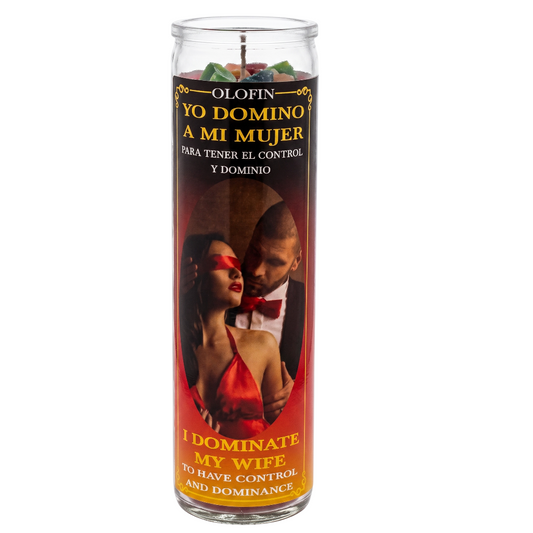 A tall glass jar candle with a Spanish and English label reading 'Yo Domino a mi Mujer' and 'I Dominate My Wife,' featuring a red-toned photo of a couple and yellow text on a white background.