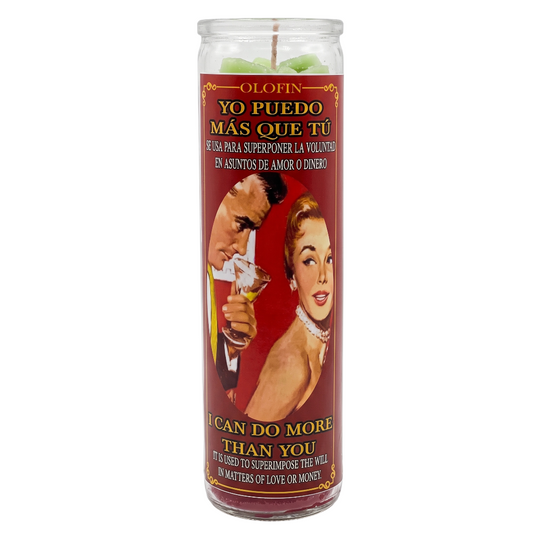 A tall glass jar candle with a red printed label featuring a retro illustration of a man and woman and Spanish and English text. The candle is shown upright on a plain white background.